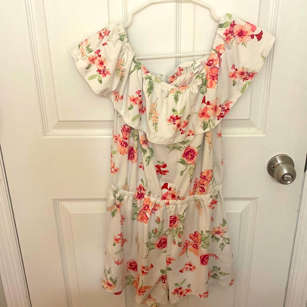 A white with pink/red flowers romper